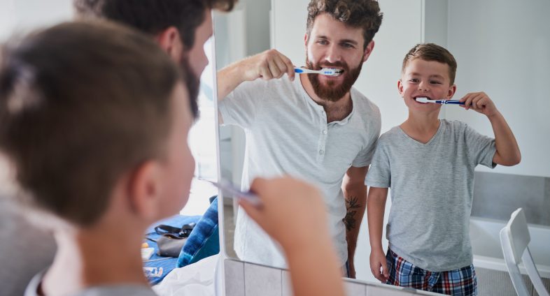 dad and son brushing teeth