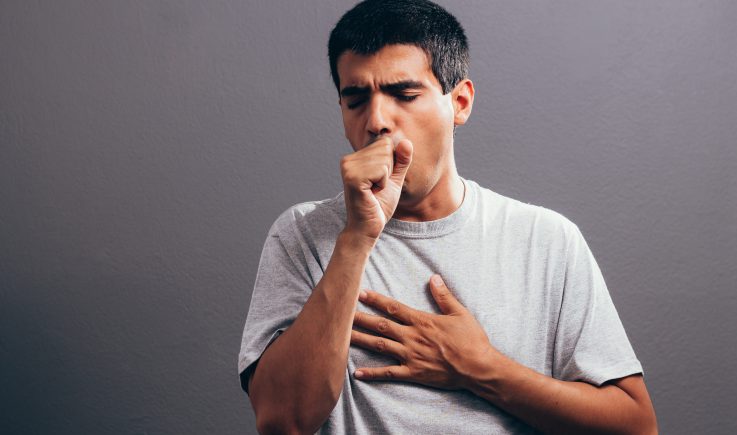 Man coughing into his hand